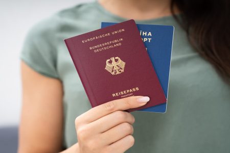 Woman Holding Two Passports. Ukrainian And German